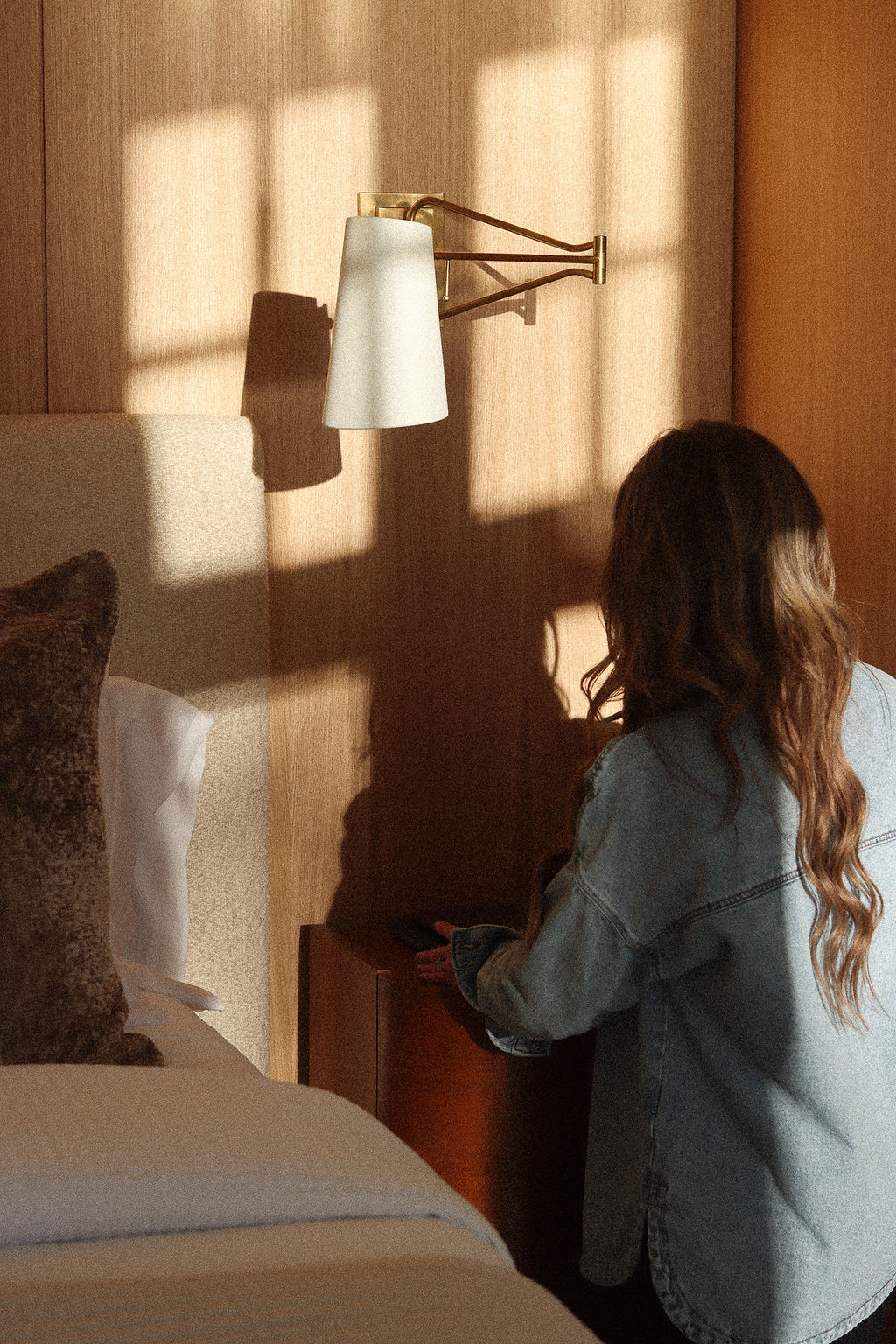 Sunlight across the wood-paneled primary bedroom